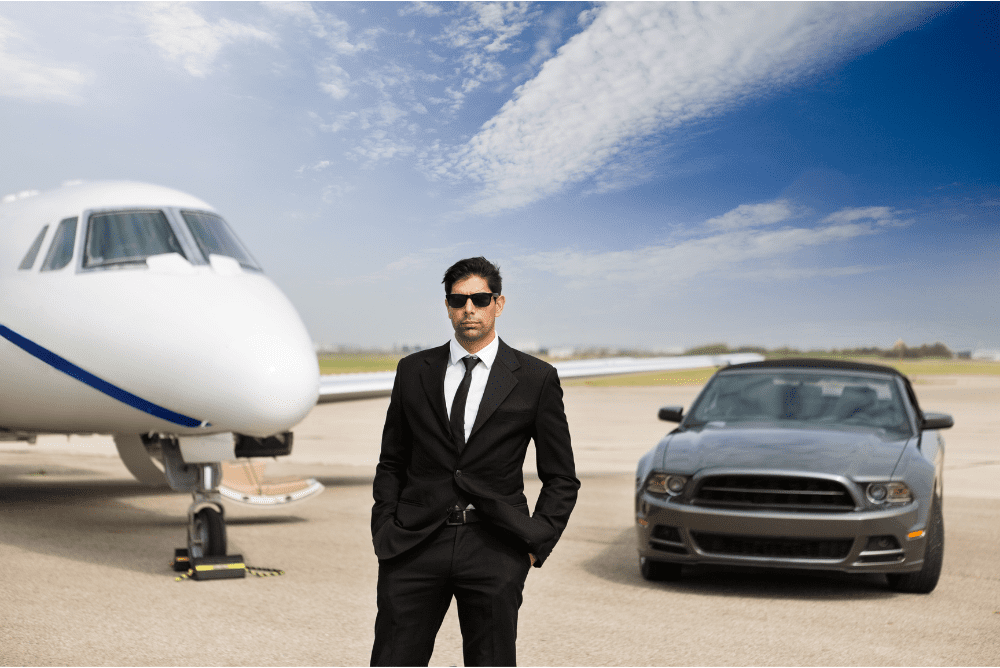 Business man with private jet and a sport car in the background